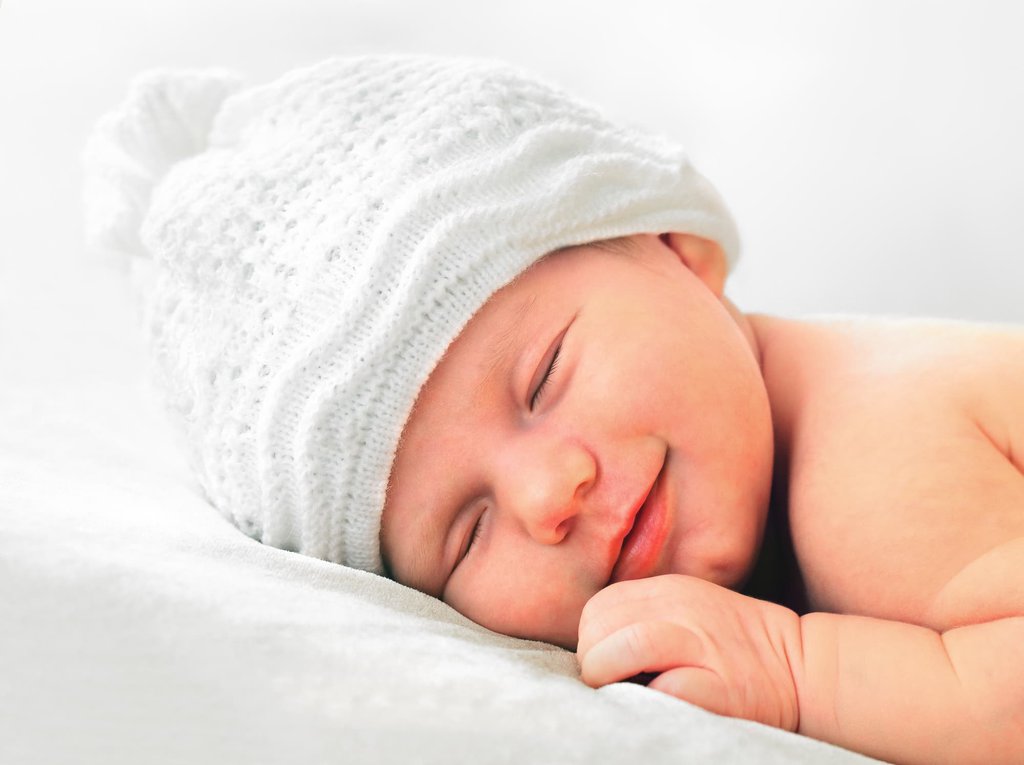 The Adorable Secret Behind Babies Smiling in Their Sleep